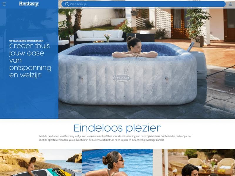 Person relaxing in a Bestway Lay-Z-Spa inflatable hot tub on a patio with outdoor furniture in the background.